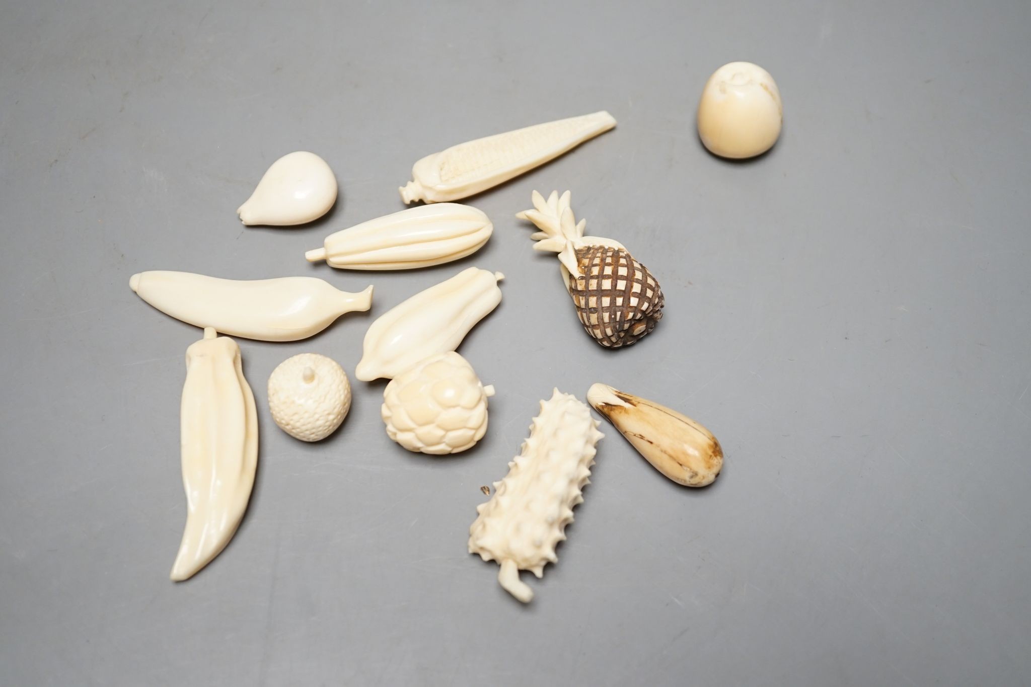 A group of Chinese carved ivory fruits, on ‘leaf’, 19cm